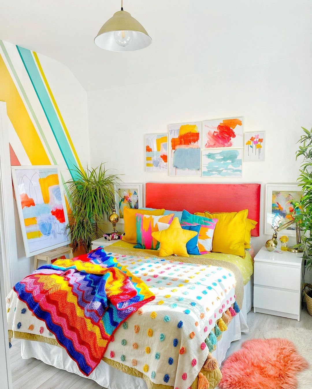 Kids Bedroom Painted White with Rainbow Colors on the Wall. Photo by Instagram user @rowans_rainbow