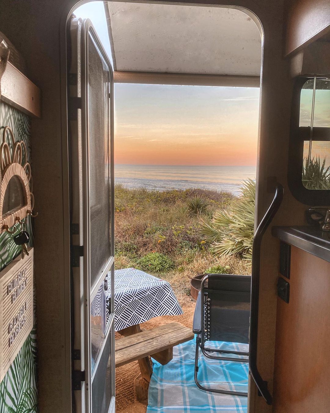 View of the Beach Looking out of the Door on an RV. Photo by Instagram user @rumbly_bumbly_rv