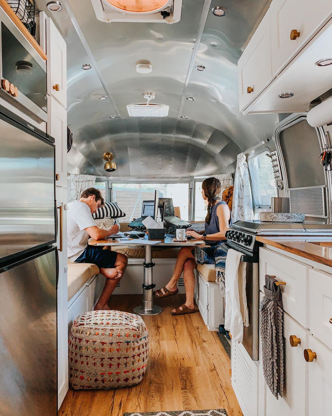 Two People Working in an Updated Airstream. Photo by Instagram user @airstreaminlive