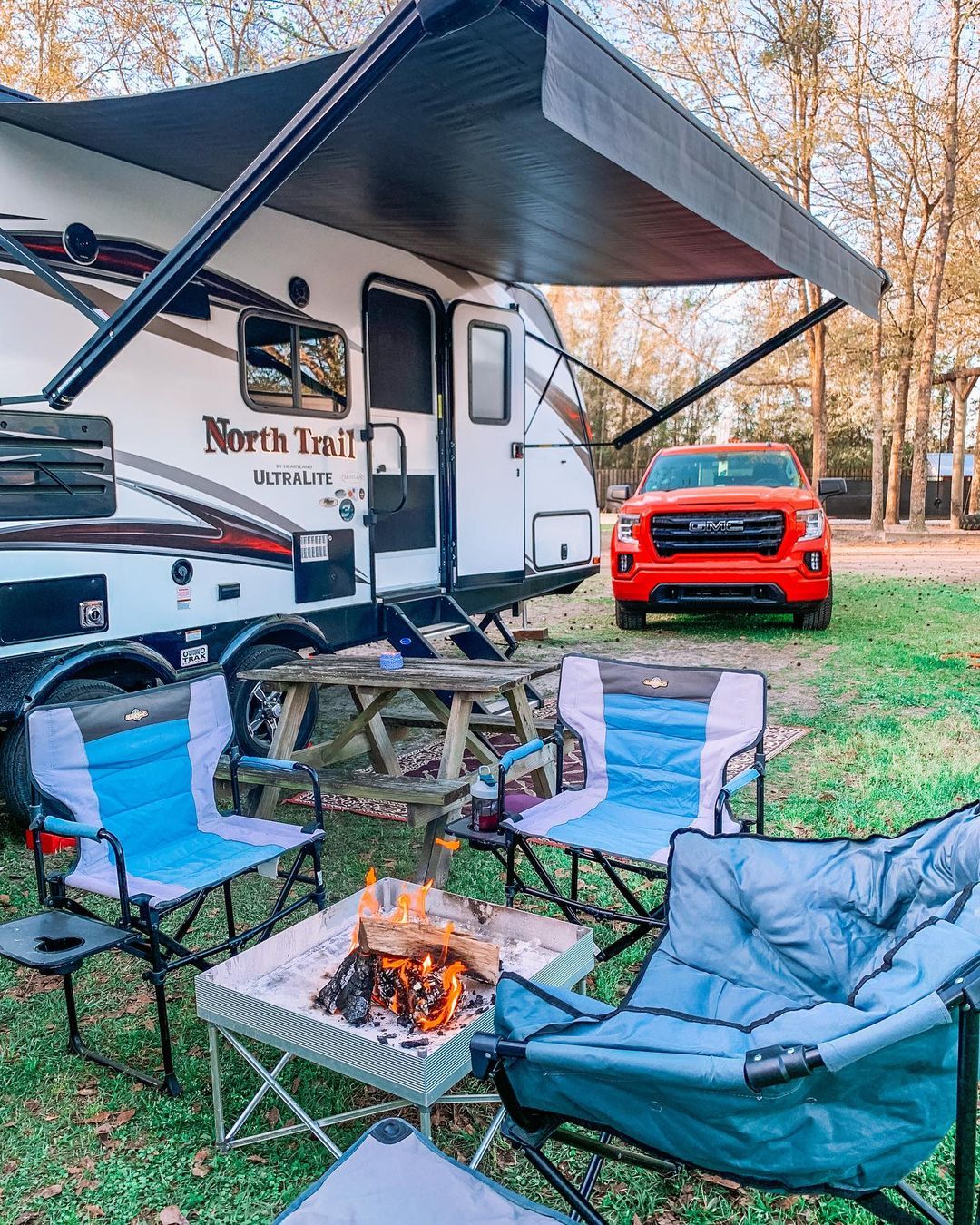 RV Set Up with Extended Canopy and Chairs Around a Fire. Photo by Instagram user @lifewithbethandcourt