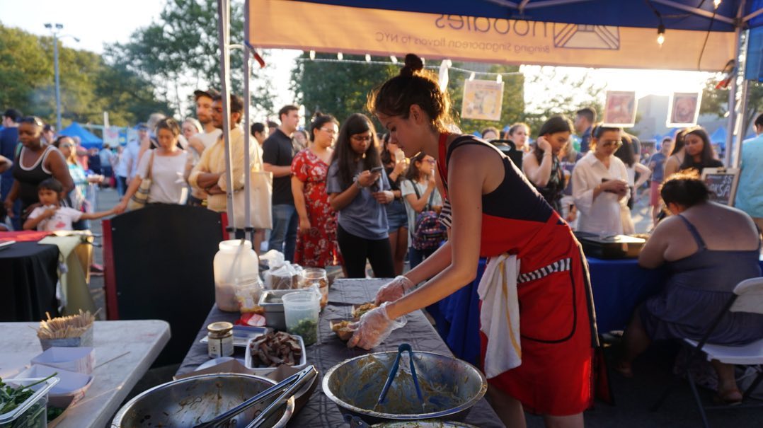 Woman preparing food at Queens Night Market photo by instagram user @queensnightmarket
