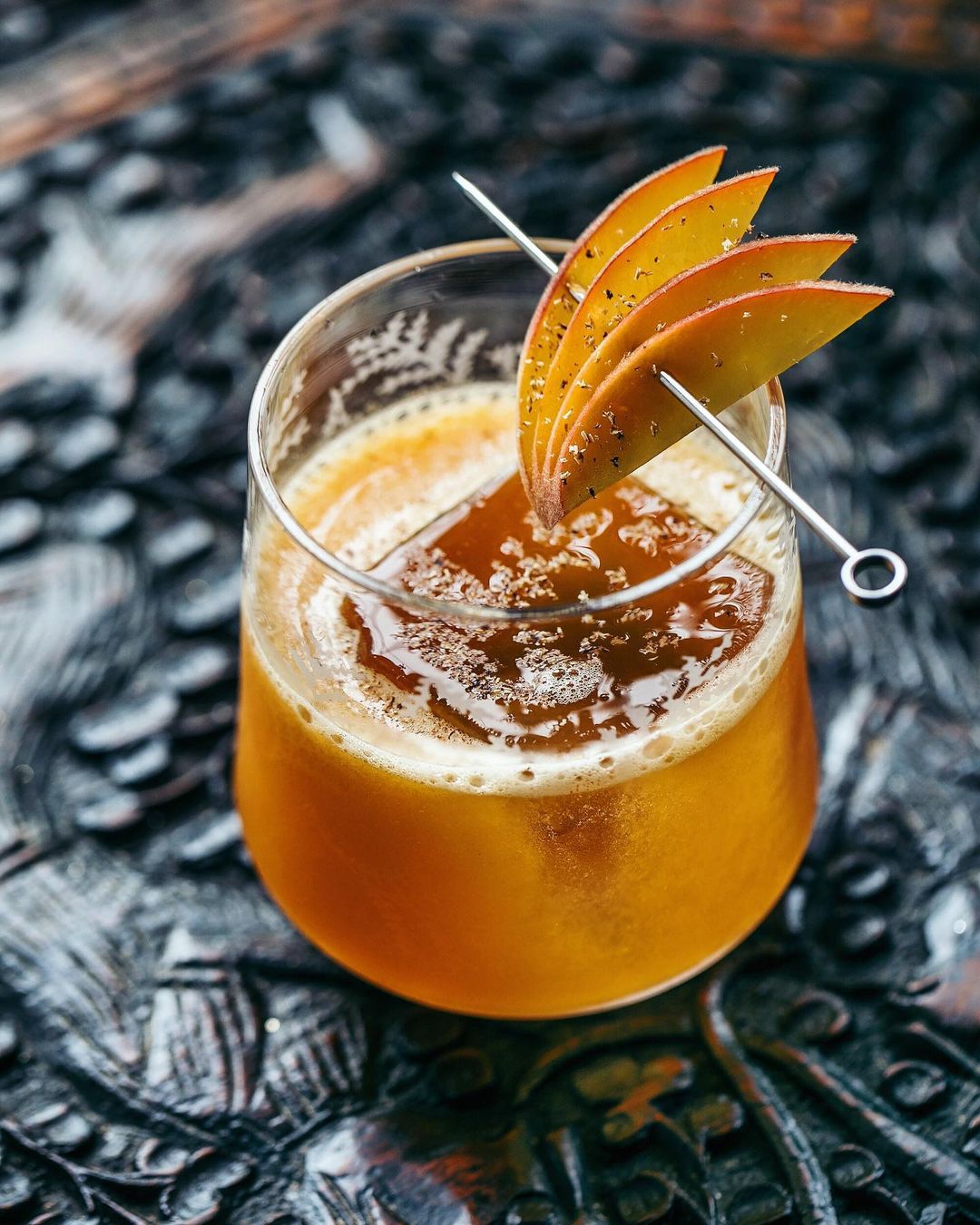 Premium cocktail with spices and peaches from a bar in Queens photo by instagram user @@shannonshootscocktails