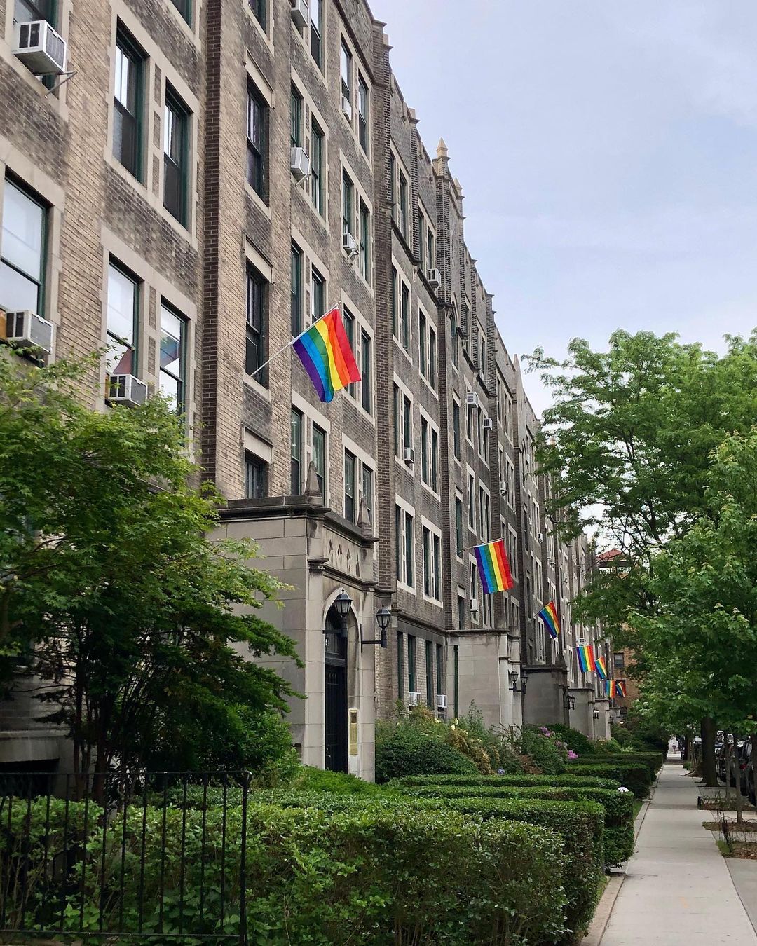 Jackson Heights greystones with rainbow flags in Queens photo by instagram user @jacksonhtslife