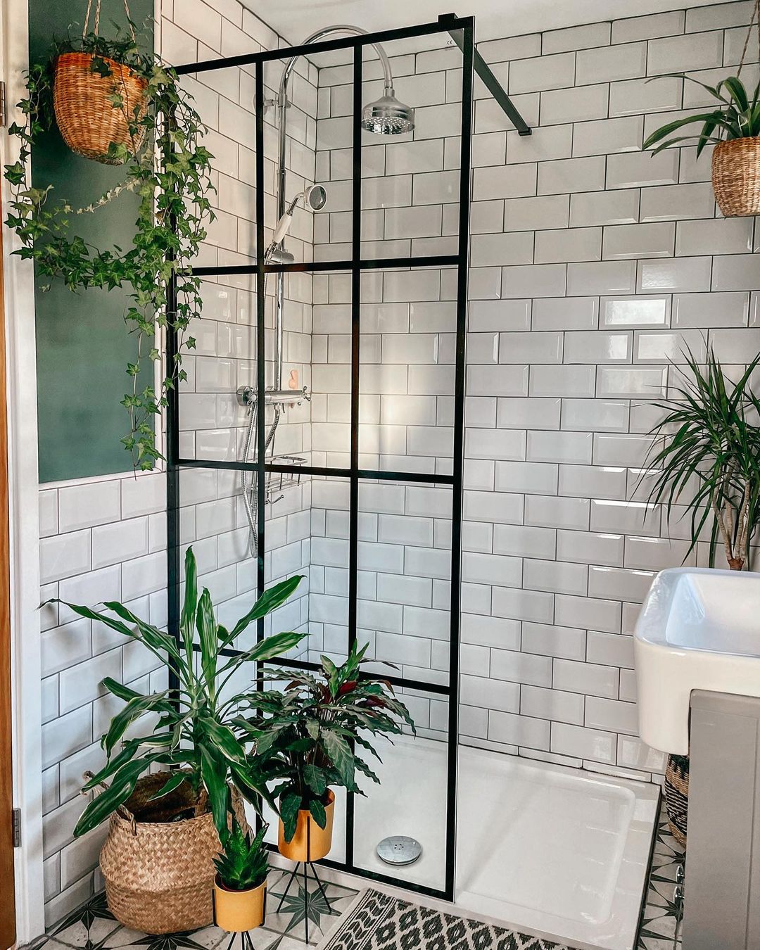 Bathroom featuring several plants. Photo by Instagram user @ahousetomakeourhome.