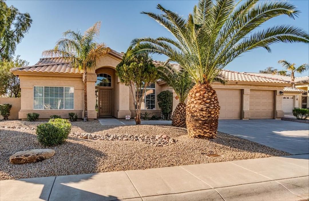 Sprawling desert ranch house in Awatukee Foothills in Phoenix with a palm tree out front. Photo by instagram user @foothillsliving