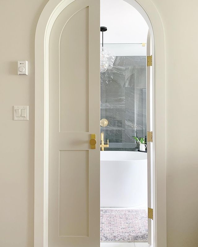 Open Door Leading to a Bathroom. Photo by Instagram user @paisleydesigninteriors