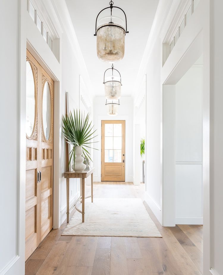 Open Foyer with White Walls and Clean Lines to the Door. Photo by Instagram user @studiopicadesign