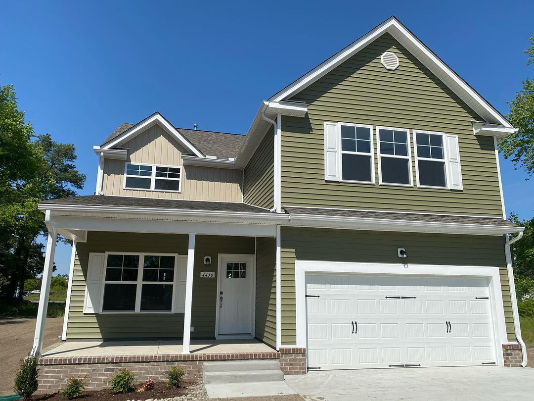 Modern two story family home painted forest green with a two car garage in Kempsville. Photo by instagram user @andyhubba