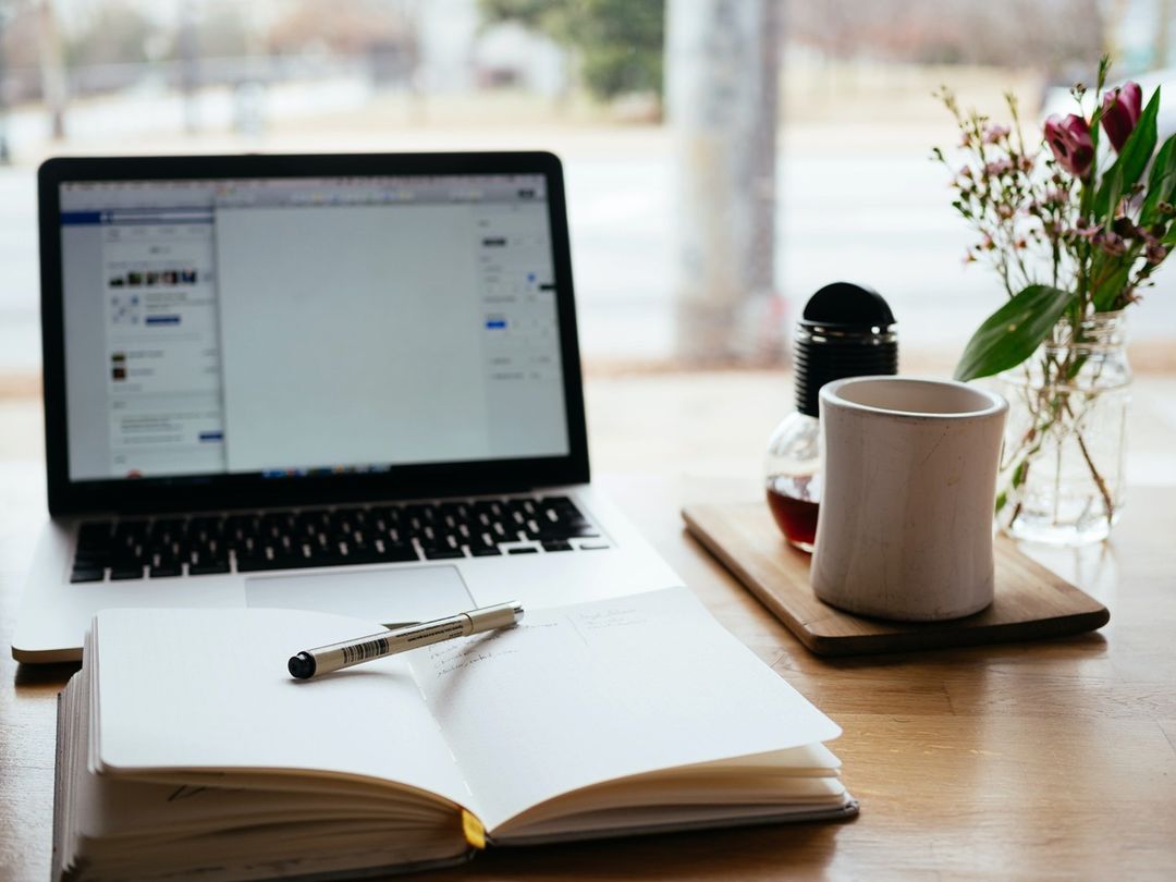 Computer and Date Book Sitting on a Desk. Photo by Instagram user @drew_kern