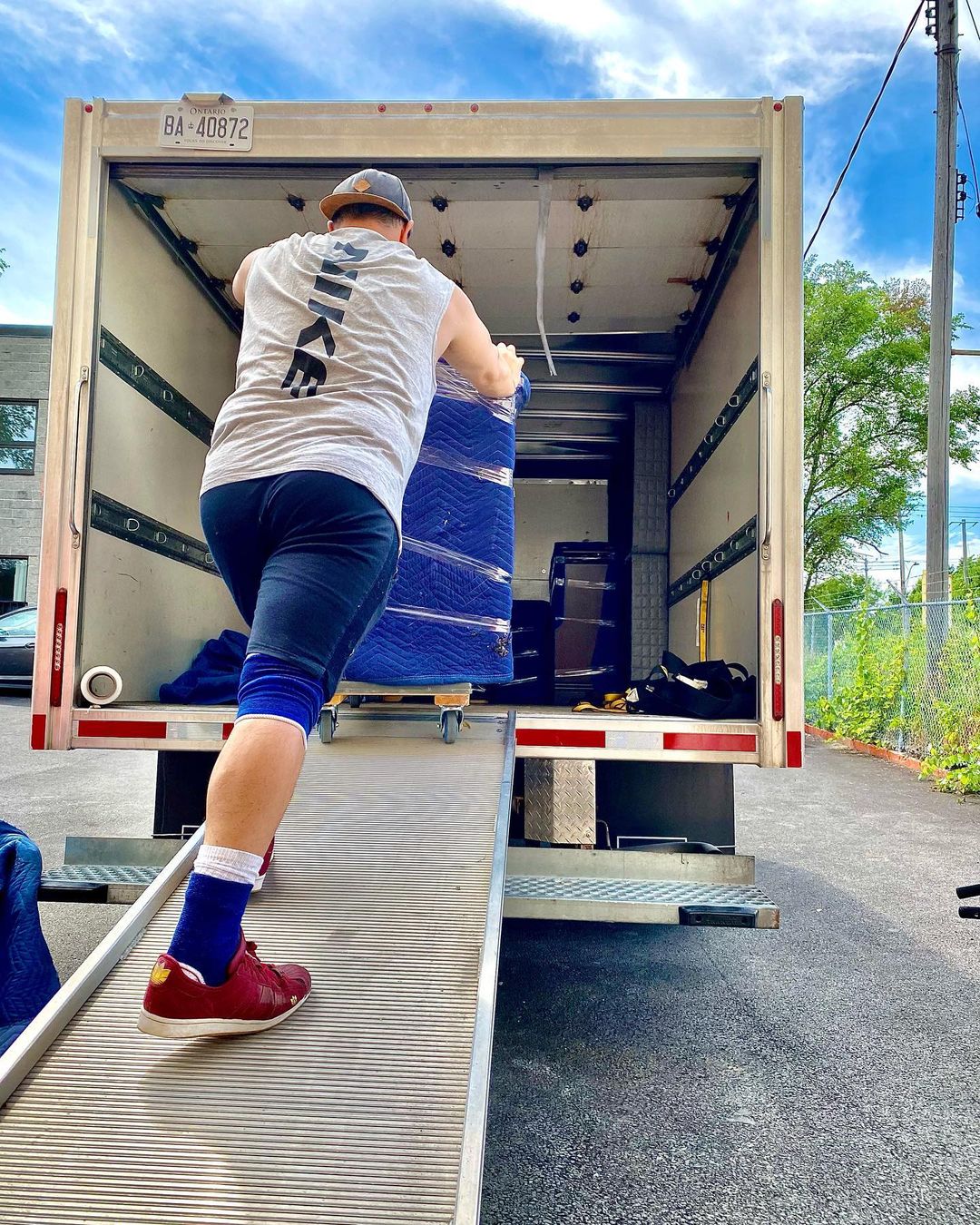 Man Moving Items into a Moving Truck. Photo by Instagram user @qtimemovers