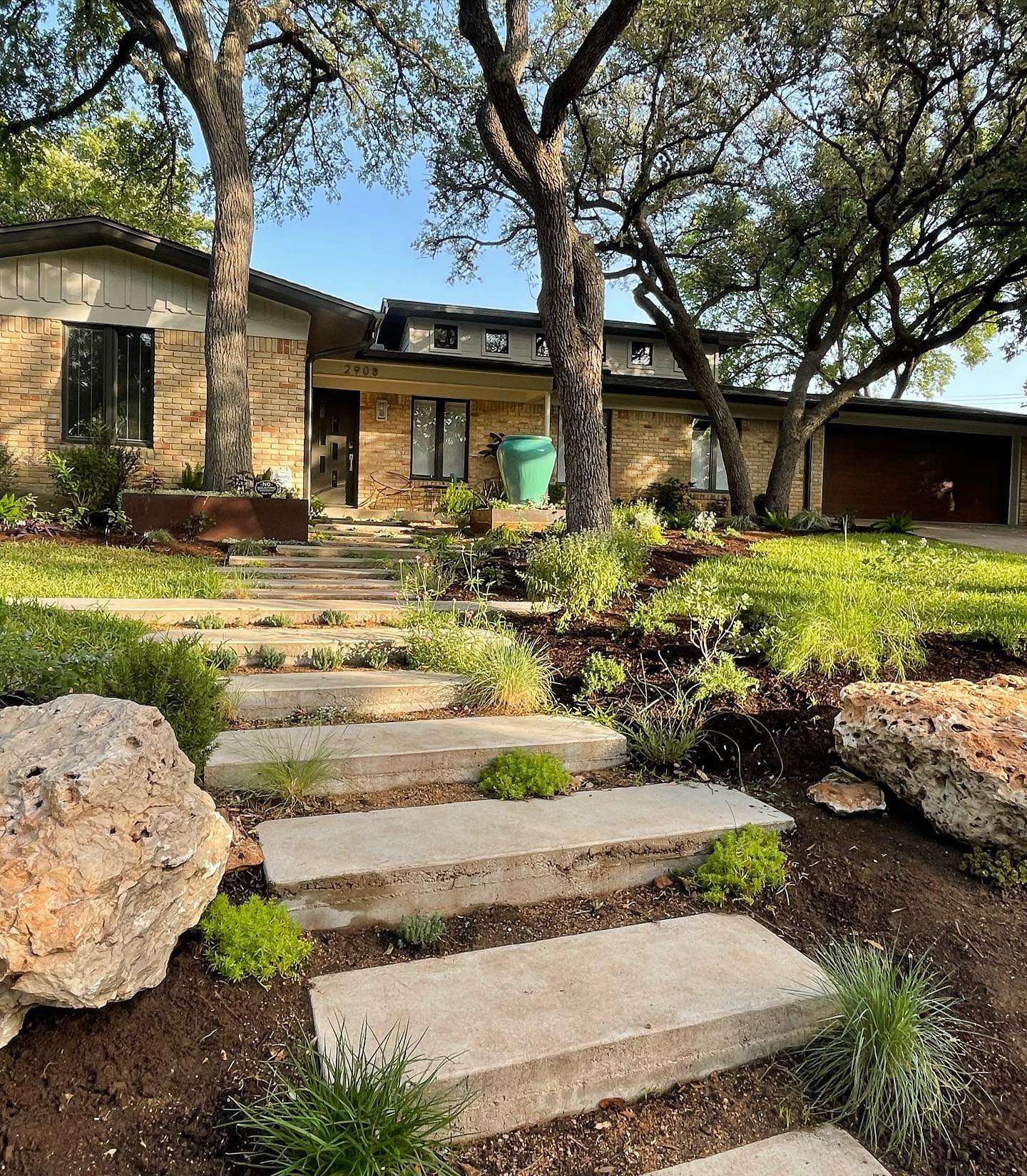 Mid-century home with stepping stones in front yard located in Barton Hills neighborhood in Austin, TX. Photo by Instagram user @1102east