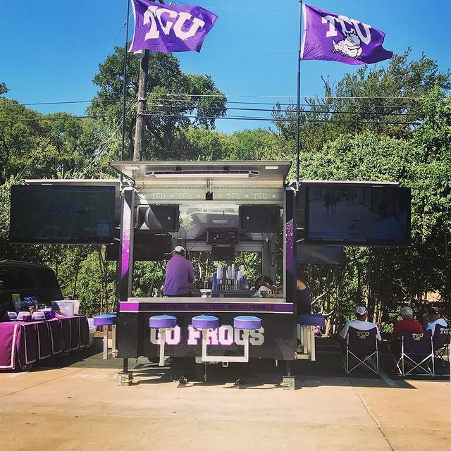TCU tailgating vehicle with bar stools, custom decals, flags and two big TVs. Photo by instagram user @jjhenrygolf