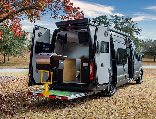 A van with all its doors open and a customized tailgating setup with a grill attached. Photo by instagram user @mercedesbenzvansusa