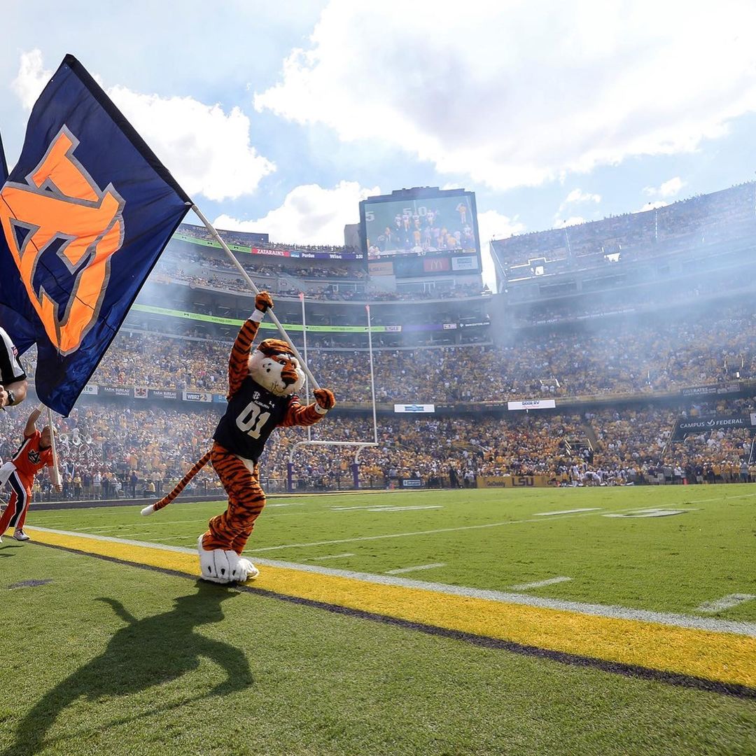 Auburn Tigers Mascot Running Down the Sideline with an Auburn Flag. Photo by Instagram user @auburn.wire