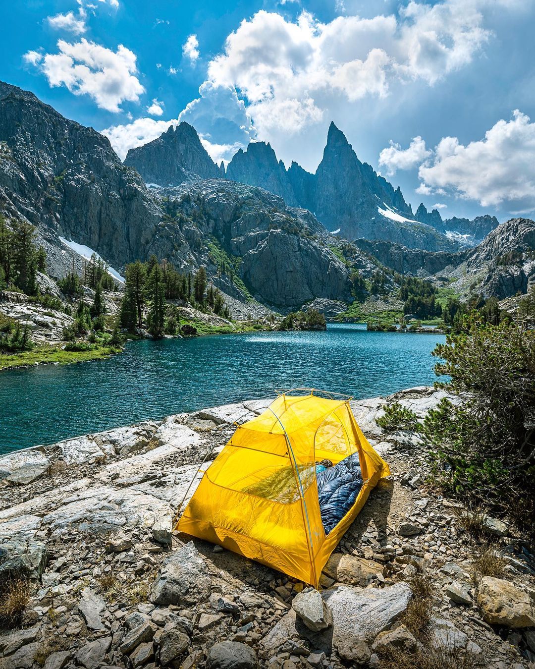 Yellow Tent Next to a River. Photo by Instagram user @v_outdoors