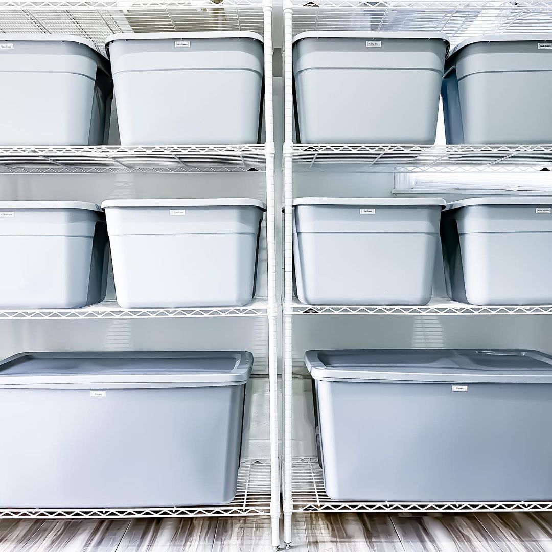 Gray Plastic Bins on White Wire Shelves. Photo by Instagram user @theprojectneat