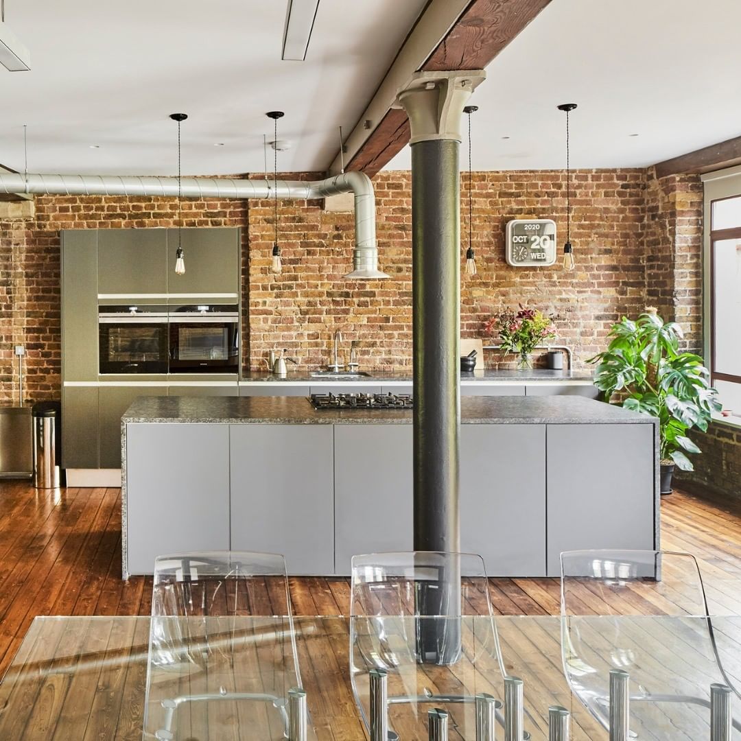 Modern open floor kitchen with exposed bricks steel structural beams. Photo by instagram user @themodernhouse