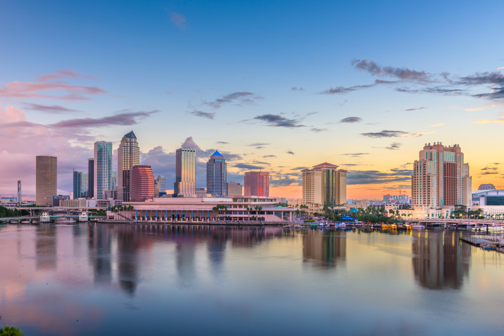 Beautiful skyline of Tampa at sunset with building reflecting on Tampa Bay.