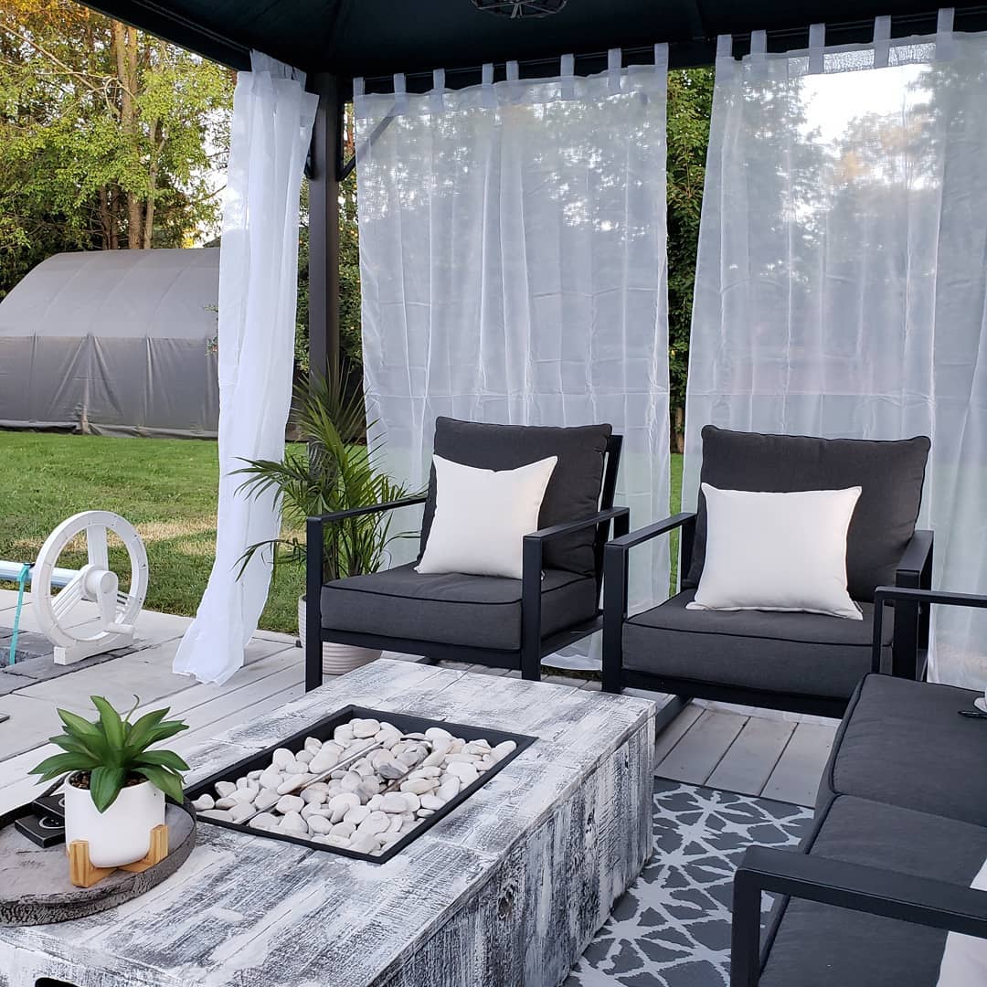 Outdoor Pergola and Seating Area Surrounded by Outdoor Curtains. Photo by Instagram user @finnishbyjes