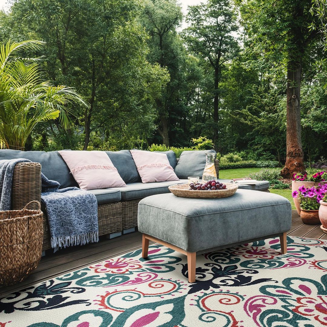 Outdoor Couch and Ottoman on an Outdoor Rug. Photo by Instagram user @kaleenrugs