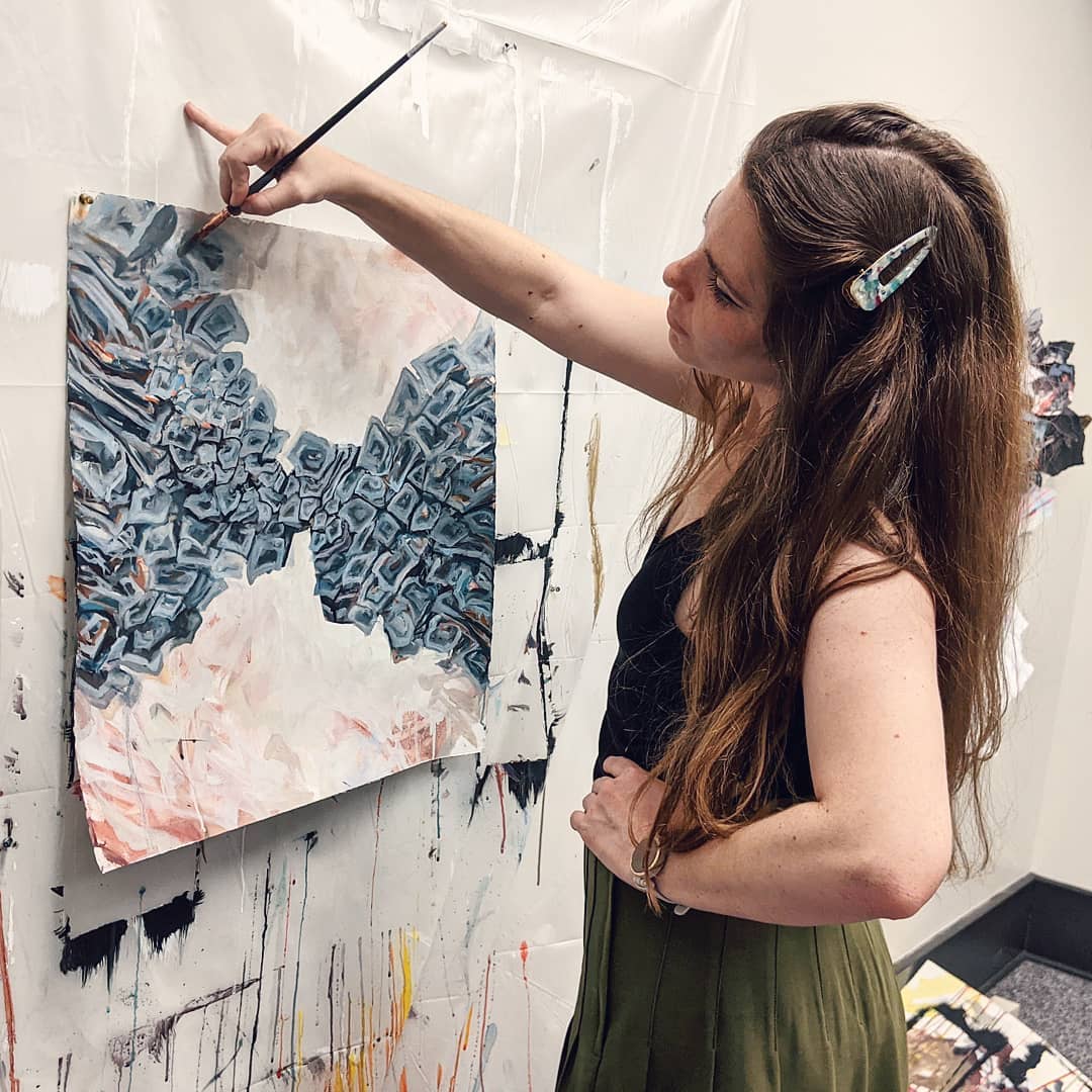 Woman Finishing a Painting at the Albany Barn. Photo by Instagram user @ashleymbusby