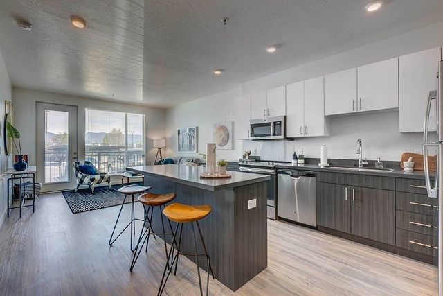 Modern apartment kitchen with bar island and leather bar stools
