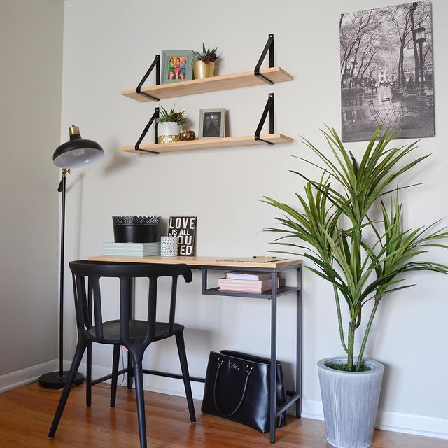 Modern bedroom furniture, small desk, metal chair, metal lamp, big floor plant, and floating bookshelves