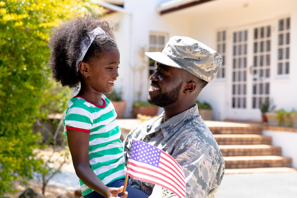 image of a veteran embracing his daughter