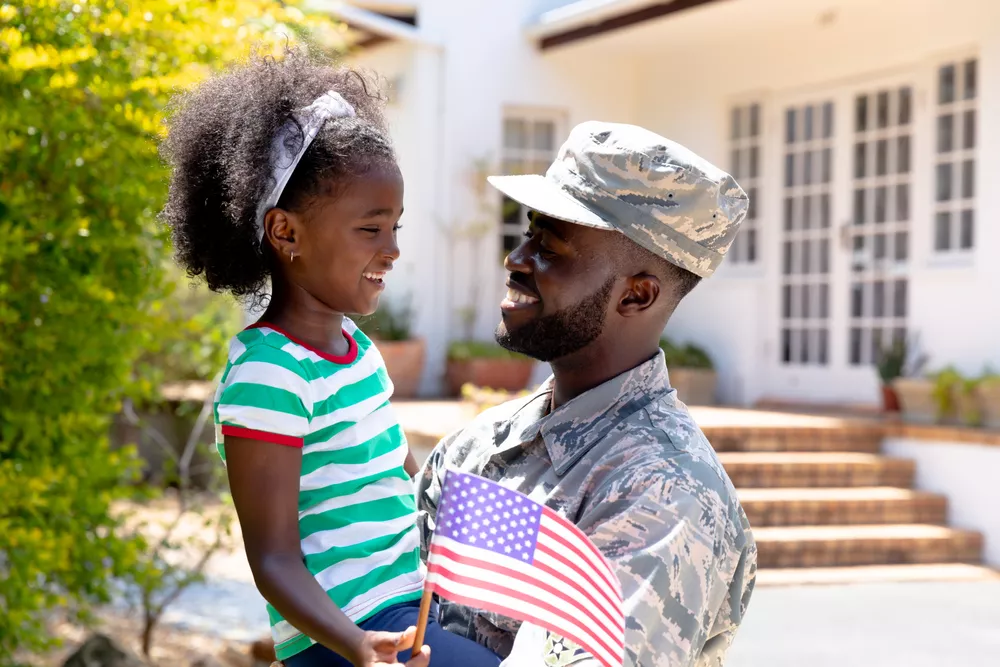 image of a veteran embracing his daughter