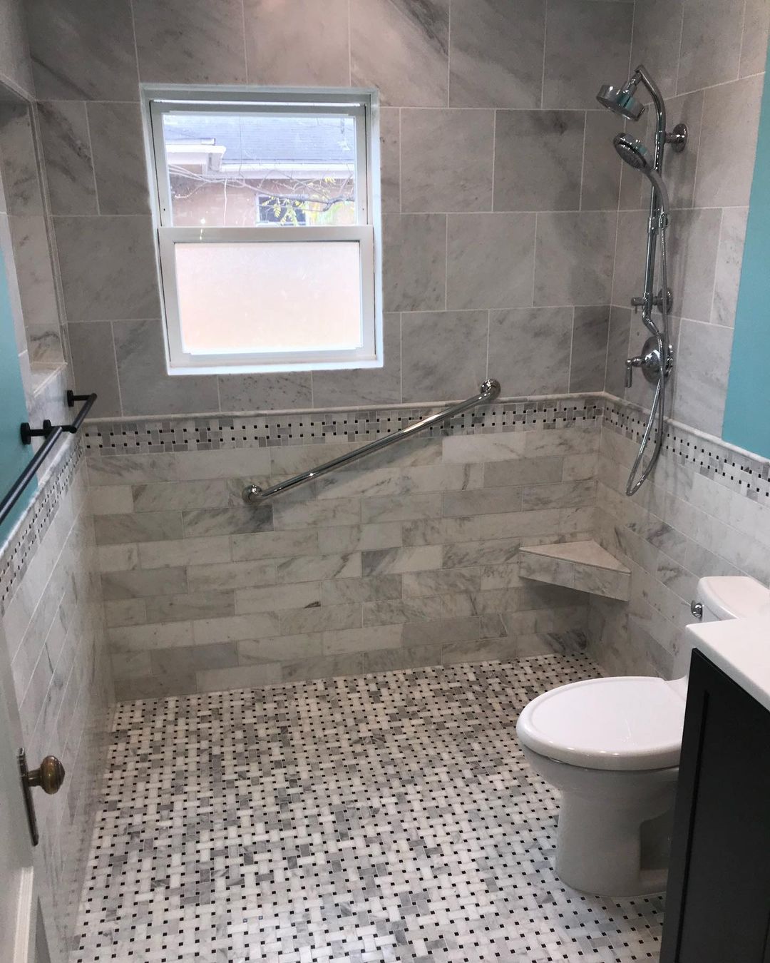 Interior view of accessible shower with modern tiles.