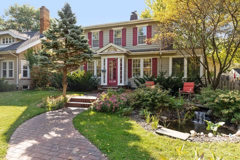 Colonia home in Minnehaha, Minneapolis, with red shutters and a peaceful water feature in the front yard. Photo by instagram user @twincitiesrob