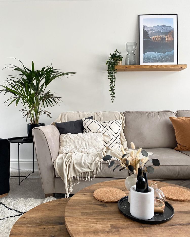 Interior view of modern living room with couch, wooden table, and decor.