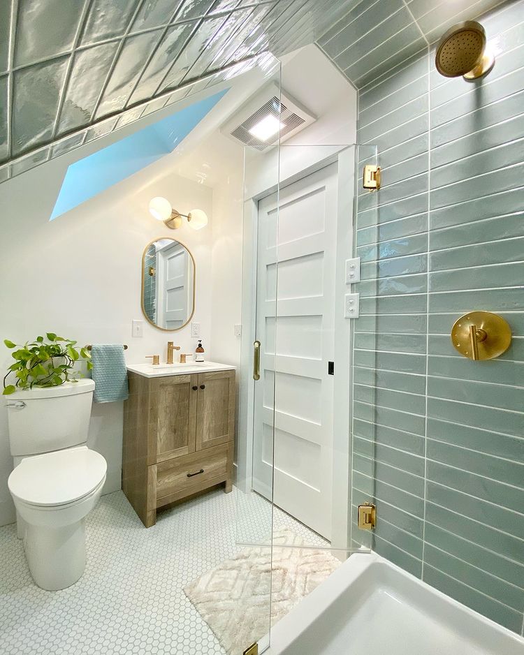 Interior view of modern bathroom with glass shower doors, a sink, and toilet.