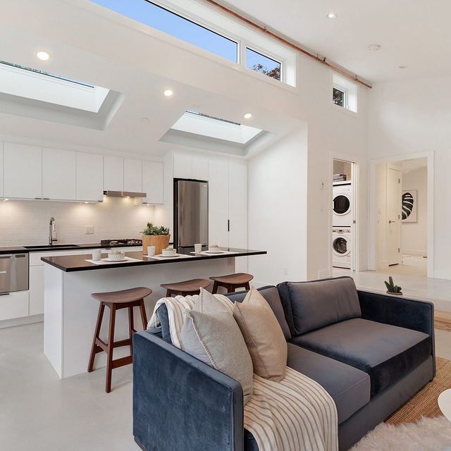 Interior view of modern family room with couch, bar, and bar stools.