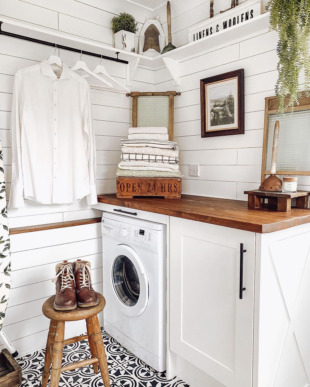 Interior view of washroom with washer, dryer, and storage.