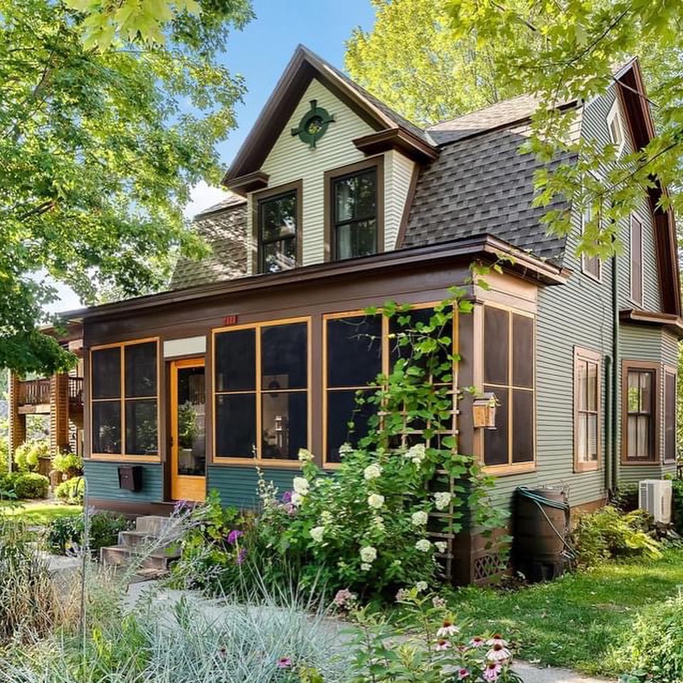 Charming home in Linden Hills, Minneapolis, with unique architecture and a massive enclosed porch with screens. Photo by instagram user @vazharwood