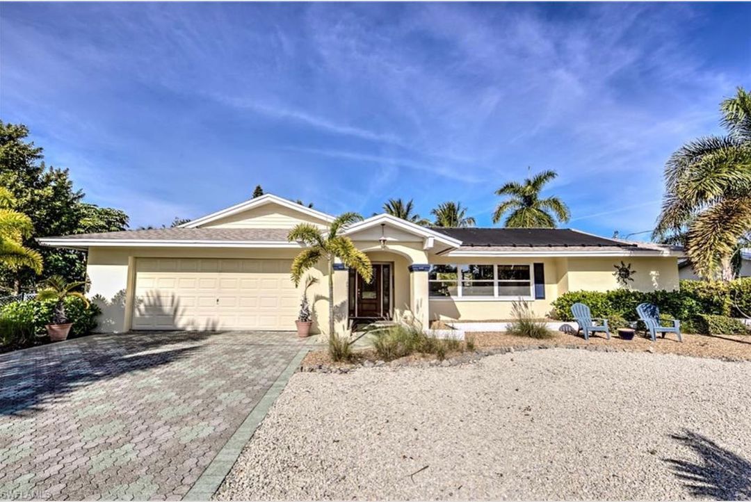 Exterior shot of cream colored house in Fort Myers Beach. Photo from Instagram user @fmbeach_waterfront