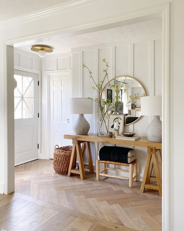 Contemporary entryway with a soft wood grain table, mirror, and matching lamps.