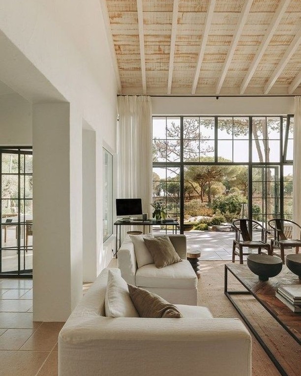 Interior view of a family room with modern arches and exposed rafters.