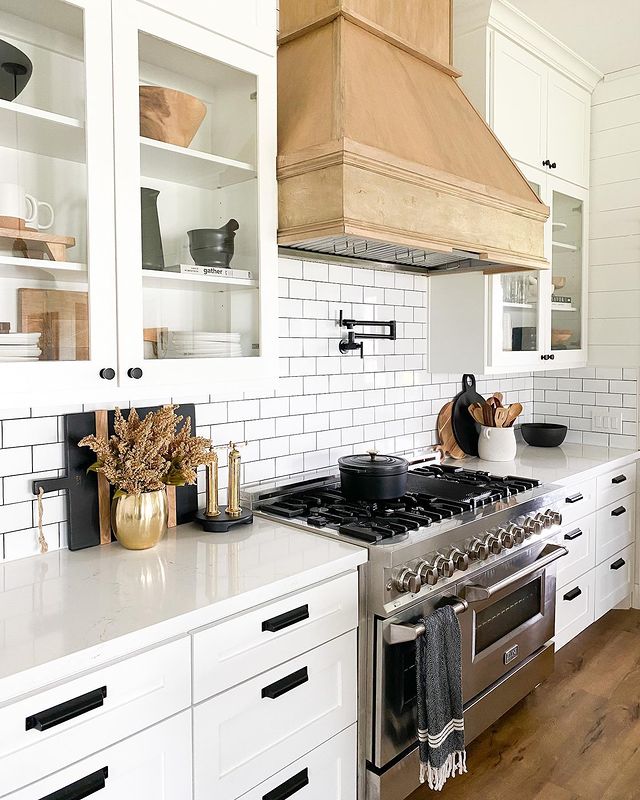 Modern kitchen with stainless steel stove and an updated hood cover