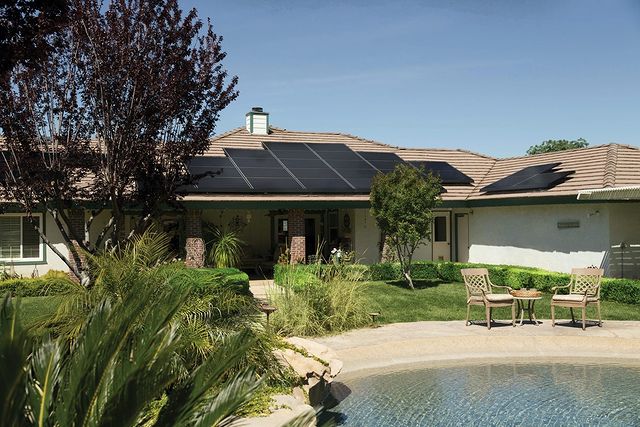 Home by a lake with solar panels on roof. Photo by Instagram user @projectbetterenergy