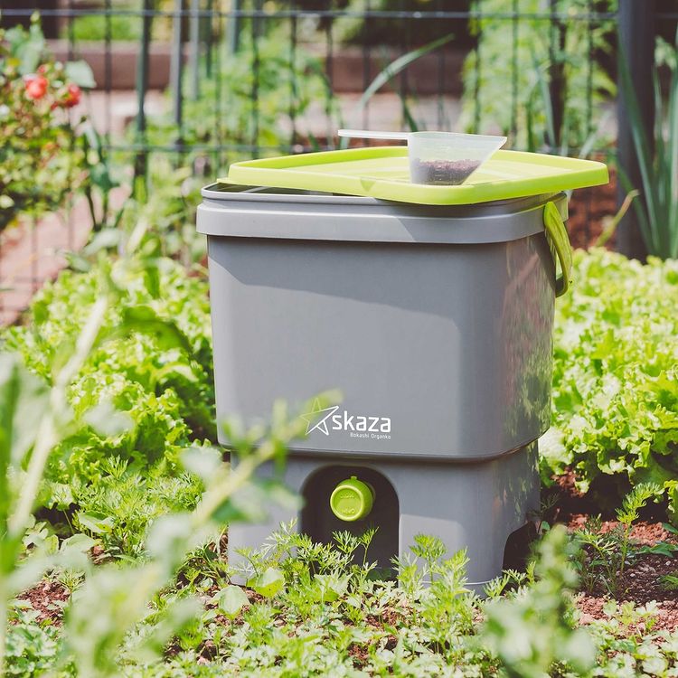 Composting bucket sitting in a garden. Instagram photo by user @allgreenuk