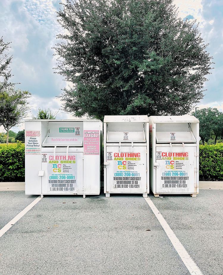 Three donation boxes in a parking lot. Photo by Instagram user @donatethisrecyclethat