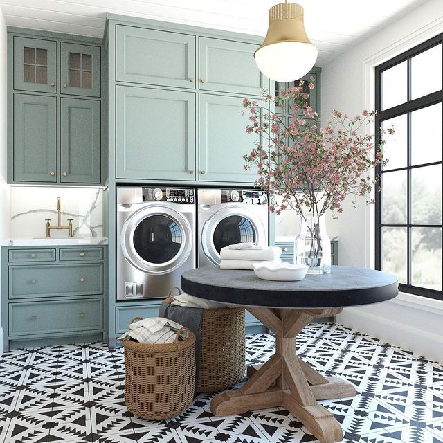 Laundry room with washer, dryer, and folding table. Instagram photo by user @ trishorndorffrealestate