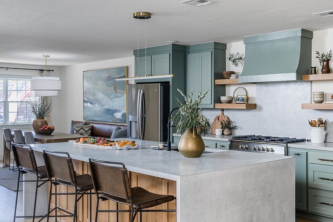 Kitchen interior with concrete countertops and waterfall island. Photo by Instagram user @daveandjennymarrs.