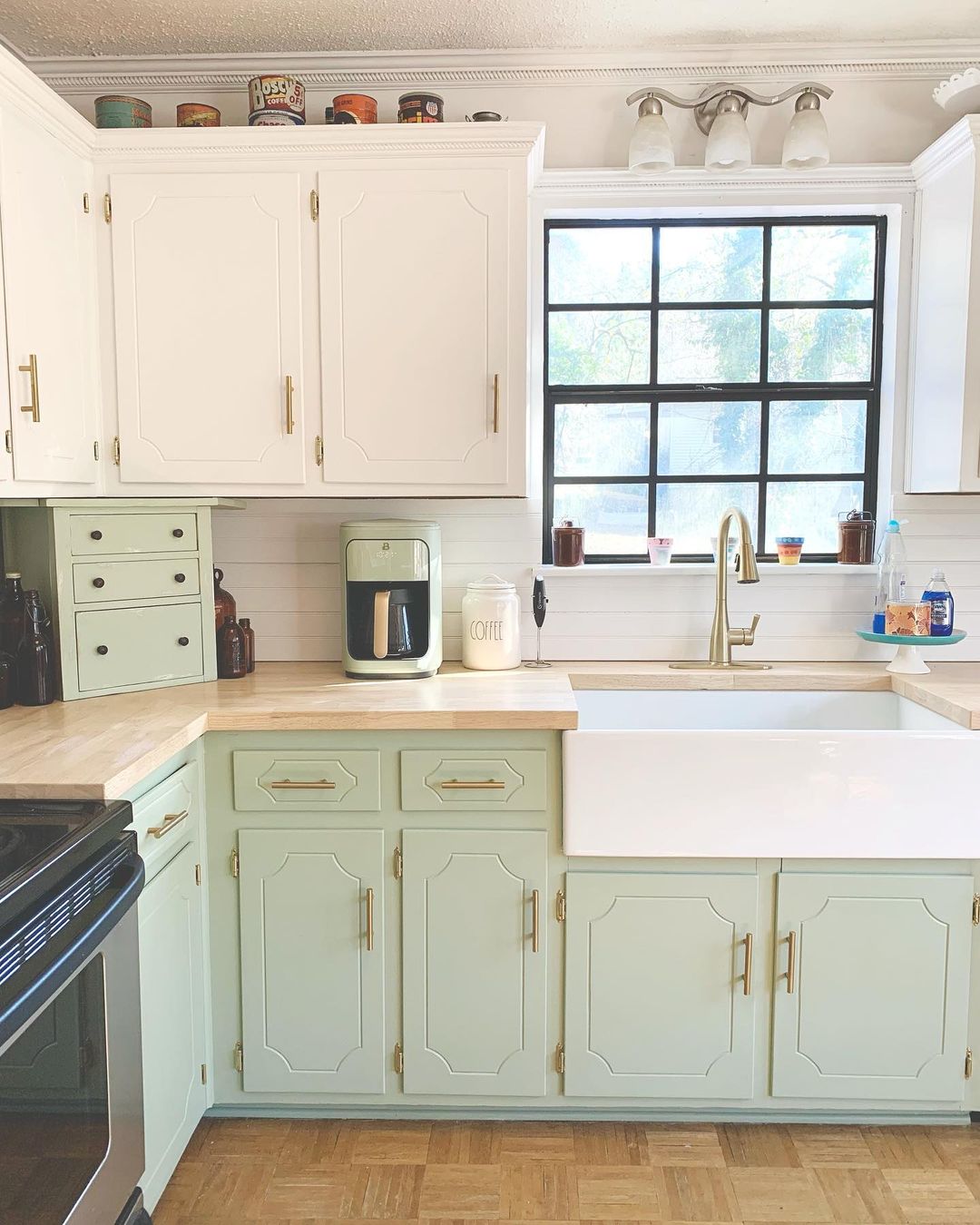 Kitchen interior with butcher block countertops and two-toned cabinets. Photo by Instagram user @rebeccaannehome.