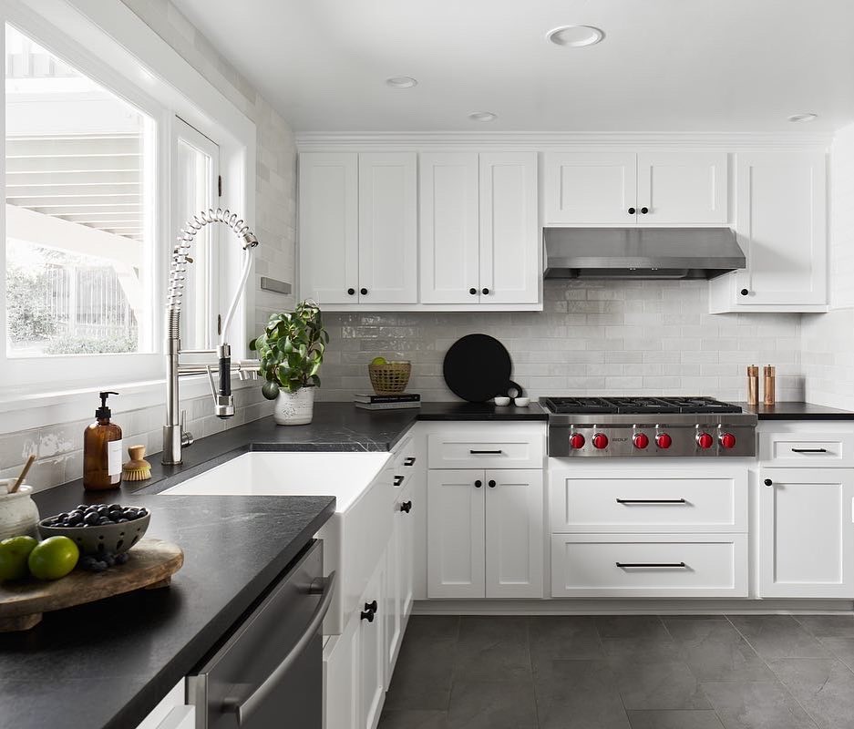 Kitchen interior with soapstone countertops and white cabinets. Photo by Instagram user @tp.remodeling.