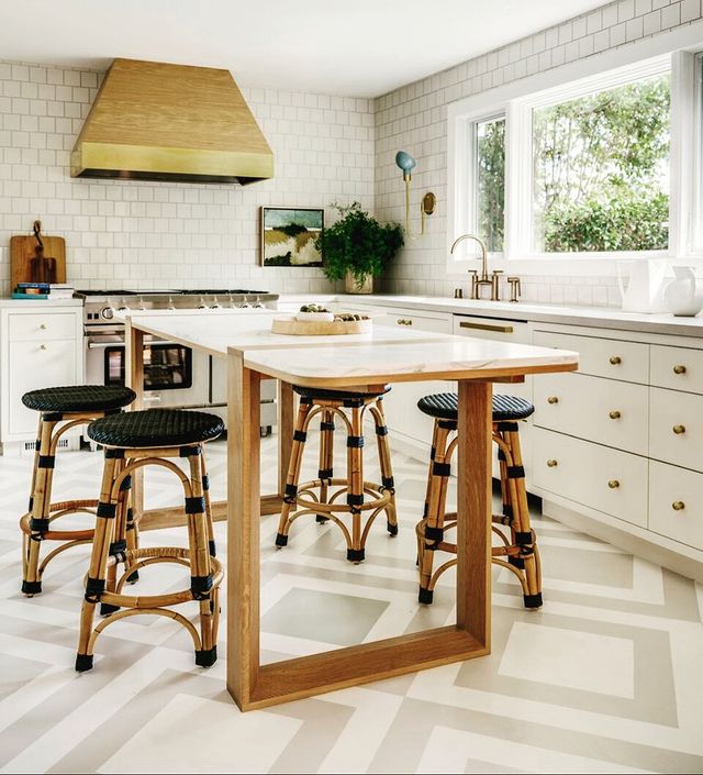 Kitchen interior with painted kitchen floors and white cabinets. Photo by Instagram user @andreacoish.