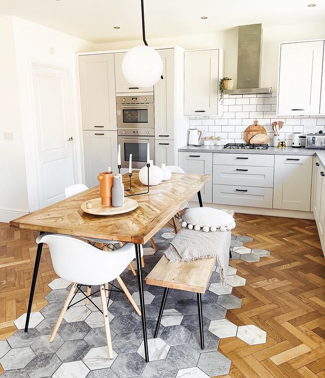 Kitchen with patterned parquet and tile flooring. Photo by Instagram user @thathousedownthere.
