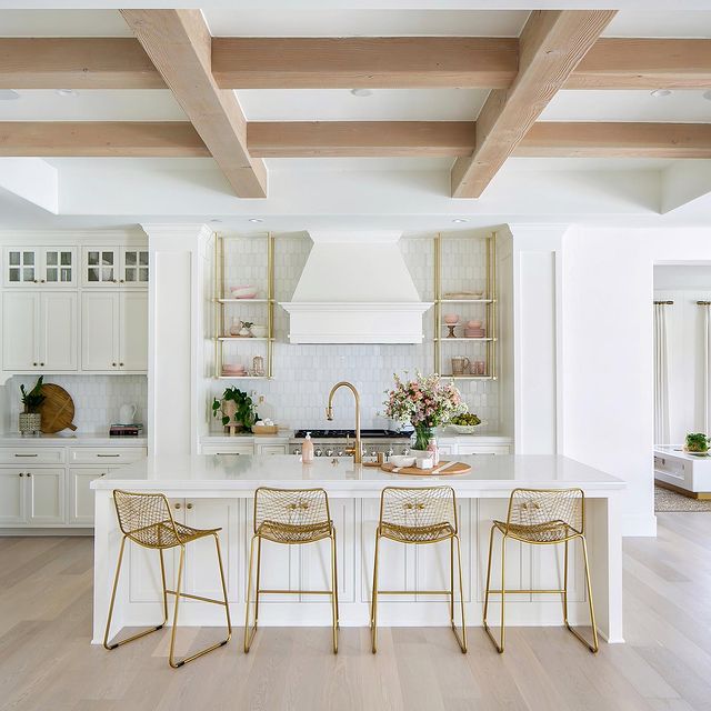 White kitchen interior with engineered wood floors. Photo by Instagram user @ryangarvin.
